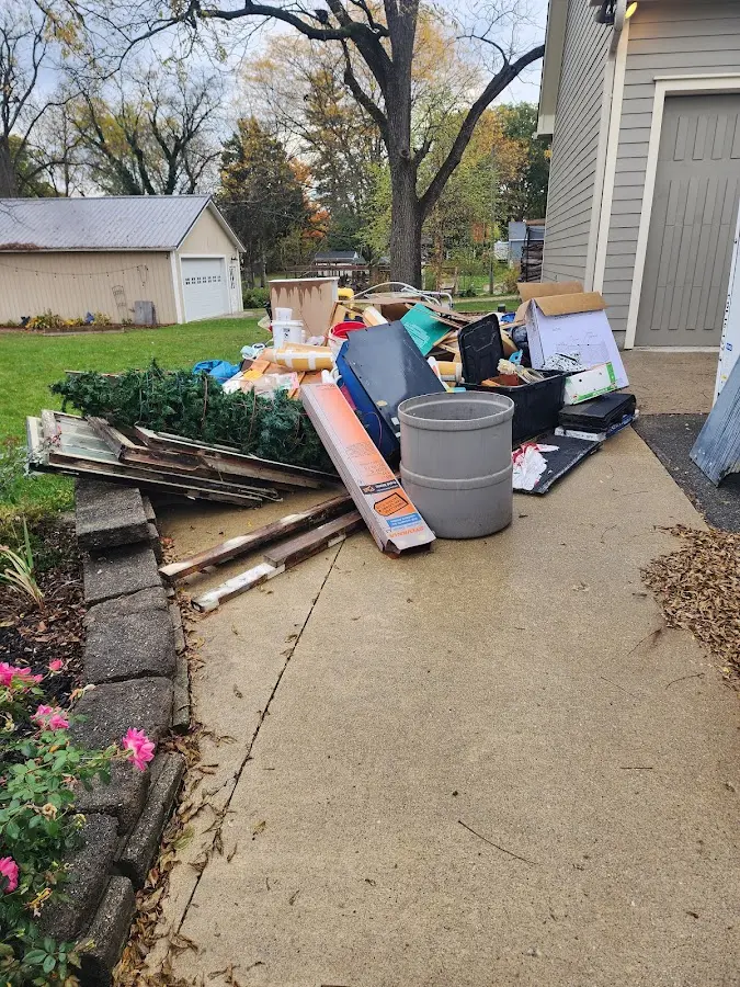 Dumpster being loaded with debris for Estate Cleanout Dumpster Rental in Wasco
